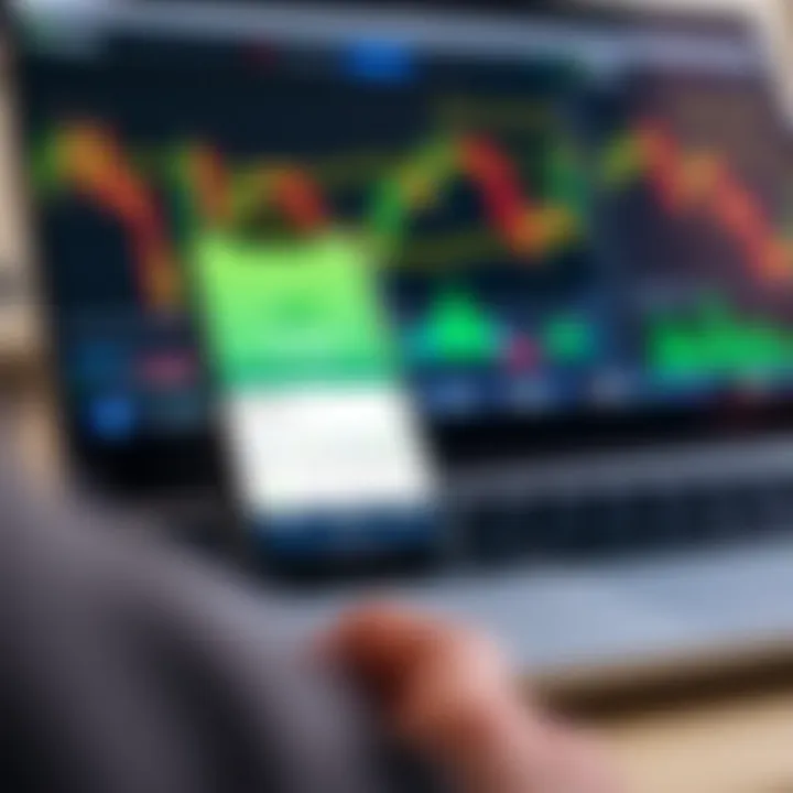 Mobile phone displaying M-Pesa app interface next to forex trading charts on a laptop